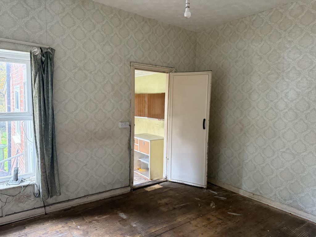 Lot: 105 - THREE-BEDROOM HOUSE IN NEED OF IMPROVEMENT - Dining room with window to garden